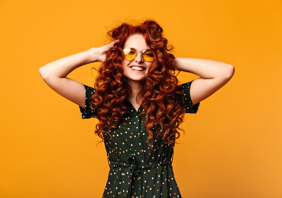 blithesome-european-girl-touching-ginger-hair-laughing-studio-shot-cheerful-young-woman-sunglasses-posing-yellow-background